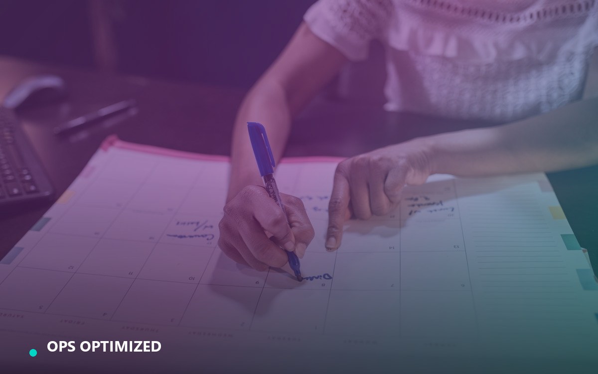 A founder reviewing payroll dates and hours on a desk planner